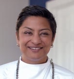 Salimah Kassim-Lakha souriante avec un col roulé blanc